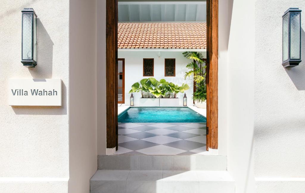 a door to a villa with a swimming pool at Villa Wahah in Seminyak