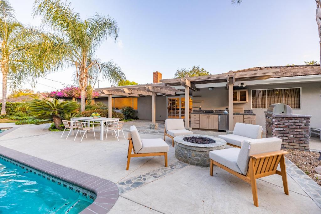 a backyard with a swimming pool and a house at @ Marbella Lane - Serene Ranch Style Home w/Pool in Fullerton