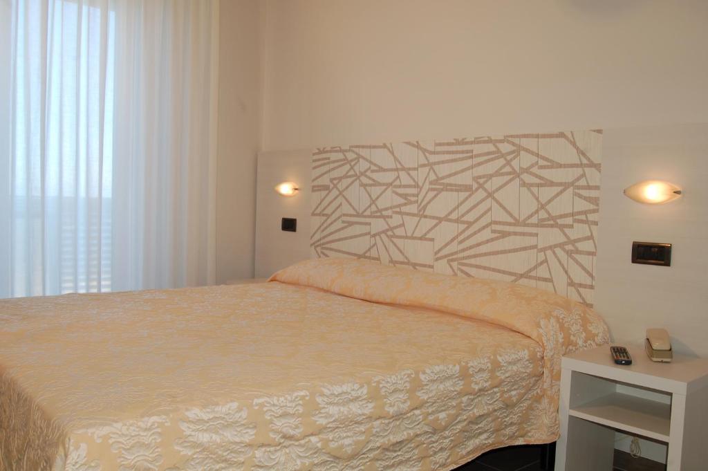 Postel nebo postele na pokoji v ubytování Hotel Alba D'Oro