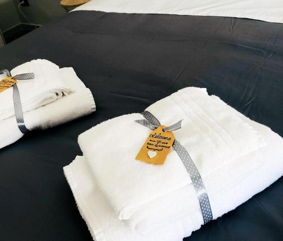 two white towels with a tag on a bed at Milano Holiday & Work House - Duomo in Milan