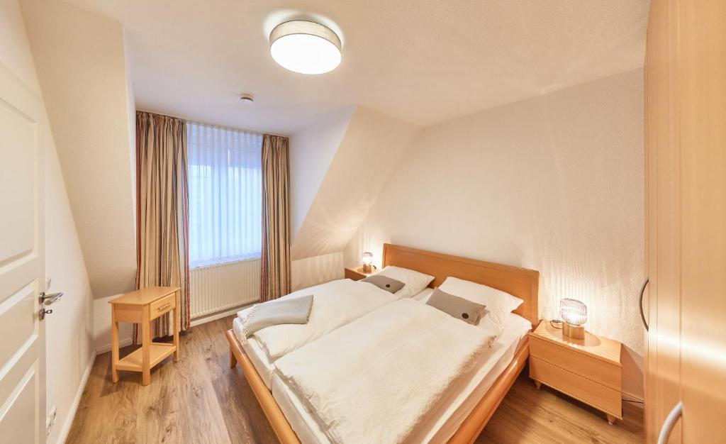 Un dormitorio con una cama grande y una ventana en Ferienwohnung mit Meerblick Grimmershörnbucht, en Cuxhaven