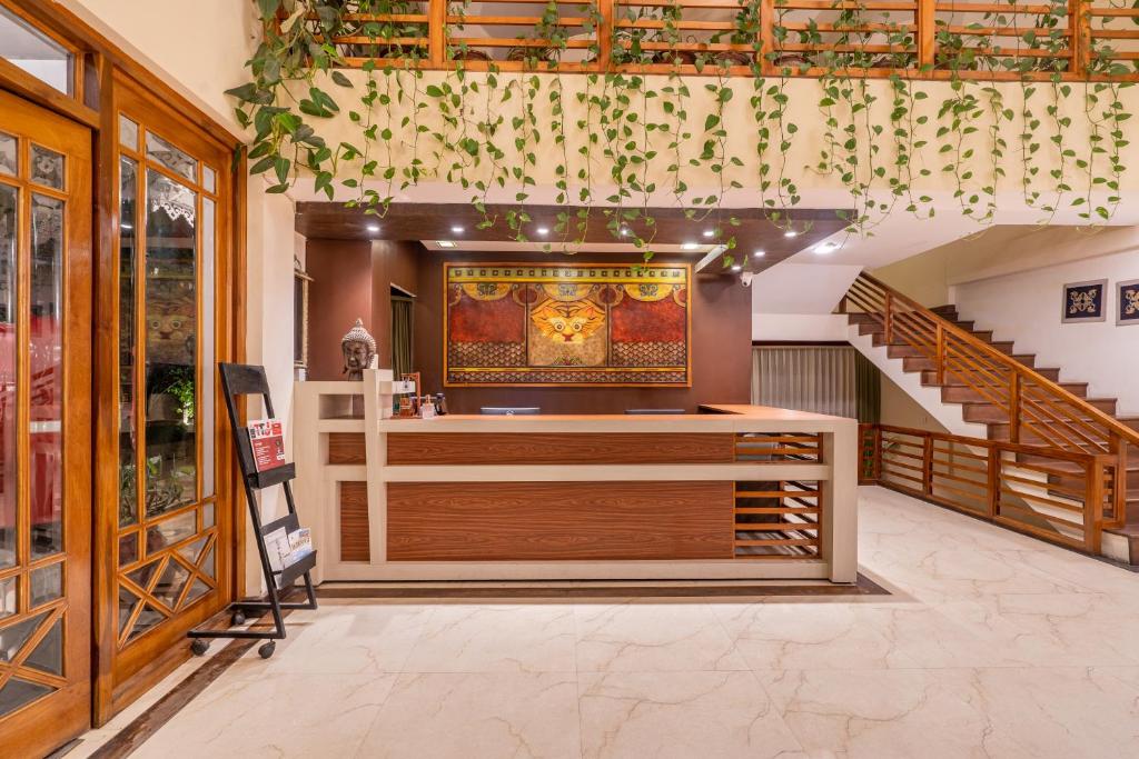 a restaurant with a counter and stairs in a building at Summit Lillium Hotel & Spa in Kalimpong