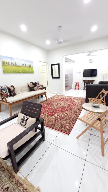 a living room with couches and a rug at The Penggawa Homestay - 3 comfortable bedrooms in Johor Bahru