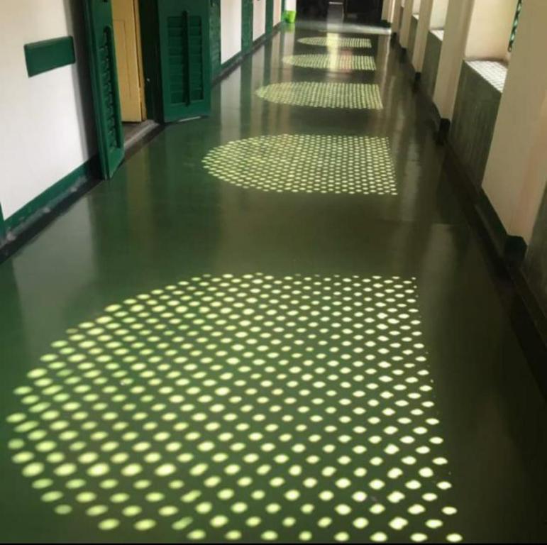 a hallway with white polka dots on the floor at YWCA GALLWAY GUEST HOUSE in Kolkata