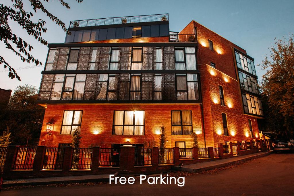 a large red brick building with a free parking at Address Boutique Hotel in Tbilisi City