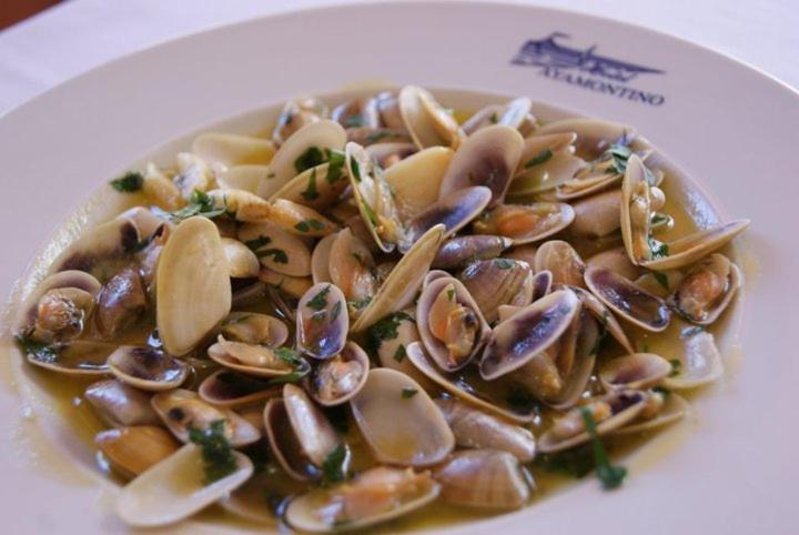 a plate of clams and mushrooms on a plate at Hotel Ayamontino in Punta Umbría