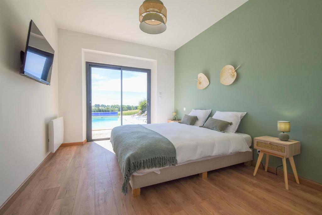 a bedroom with a bed and a tv and a window at Domaine d&#39;Essendiéras in Saint-Médard-dʼExcideuil