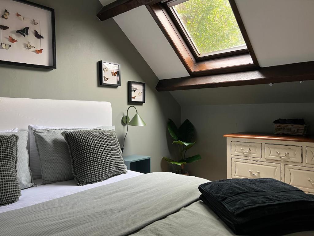 a bedroom with a white bed with a skylight at The Loft, 1 Bedroom flat in rural village in Lockton