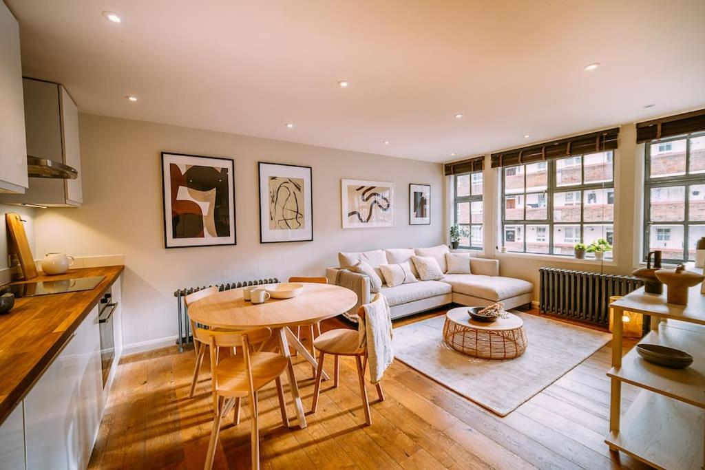 a living room with a table and a couch at The Old Tea Factory in London