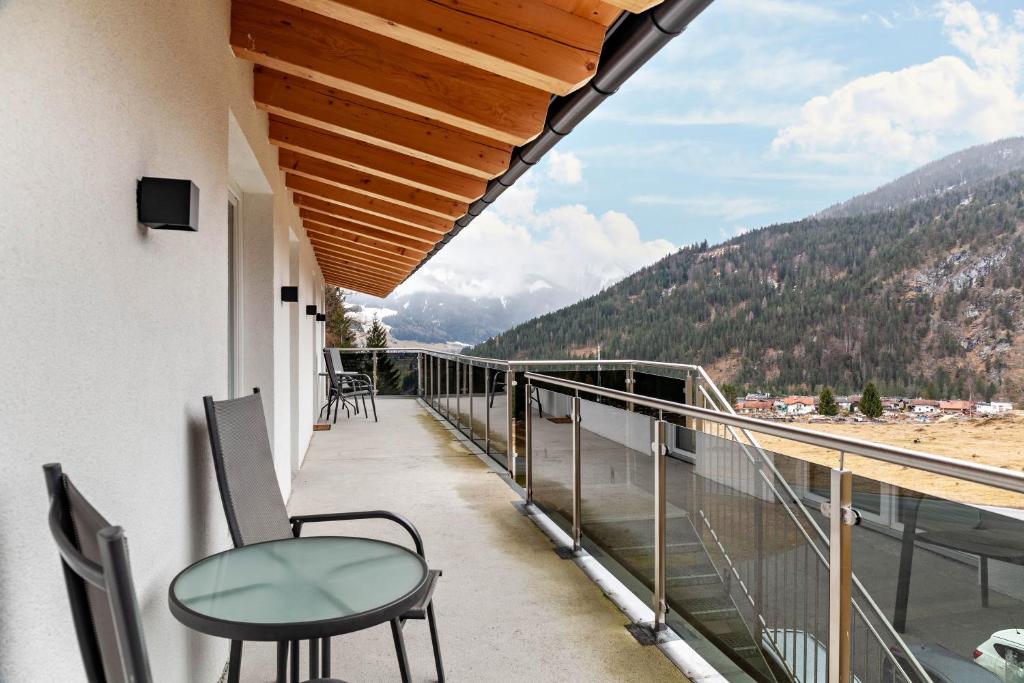 a balcony with chairs and a view of the mountains at Ferienwohnung Daniel in Ehrwald