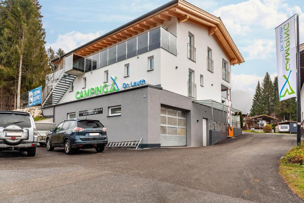 a building with cars parked in front of it at Ferienwohnung Daniel in Ehrwald