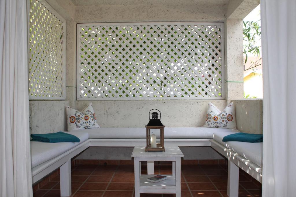 a living room with a couch and a window at Bayahibe Guest House Hotel in Bayahibe