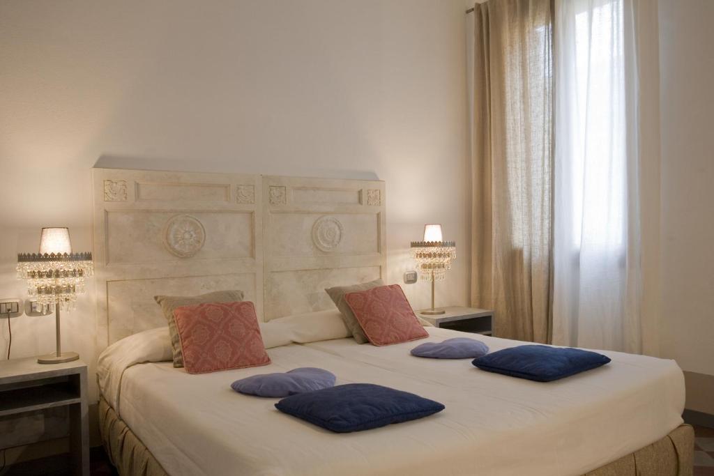Łóżko lub łóżka w pokoju w obiekcie Art Hotel Al Fagiano