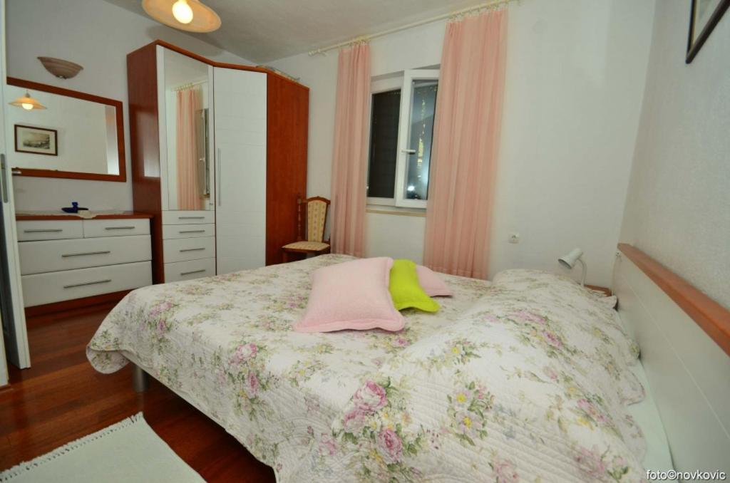 ボルにあるApartment in Bol with sea view, terrace, air conditioning,WiFi 3634-2のベッドルーム1室(ピンクと黄色の枕が付いたベッド1台付)