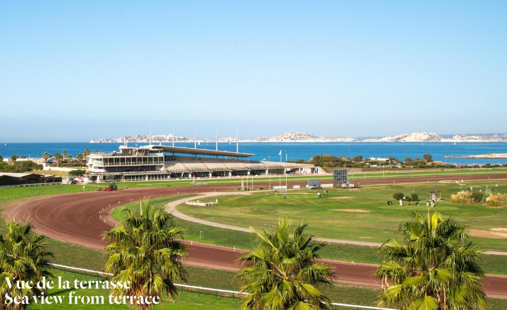 a view of a race track in front of a building at Golden Tulip Villa Massalia in Marseille