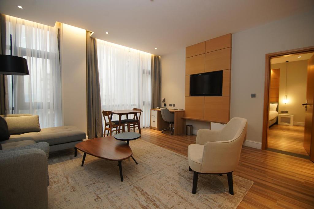 a living room with a couch and a table at Loft Hotel Apartment in Addis Ababa