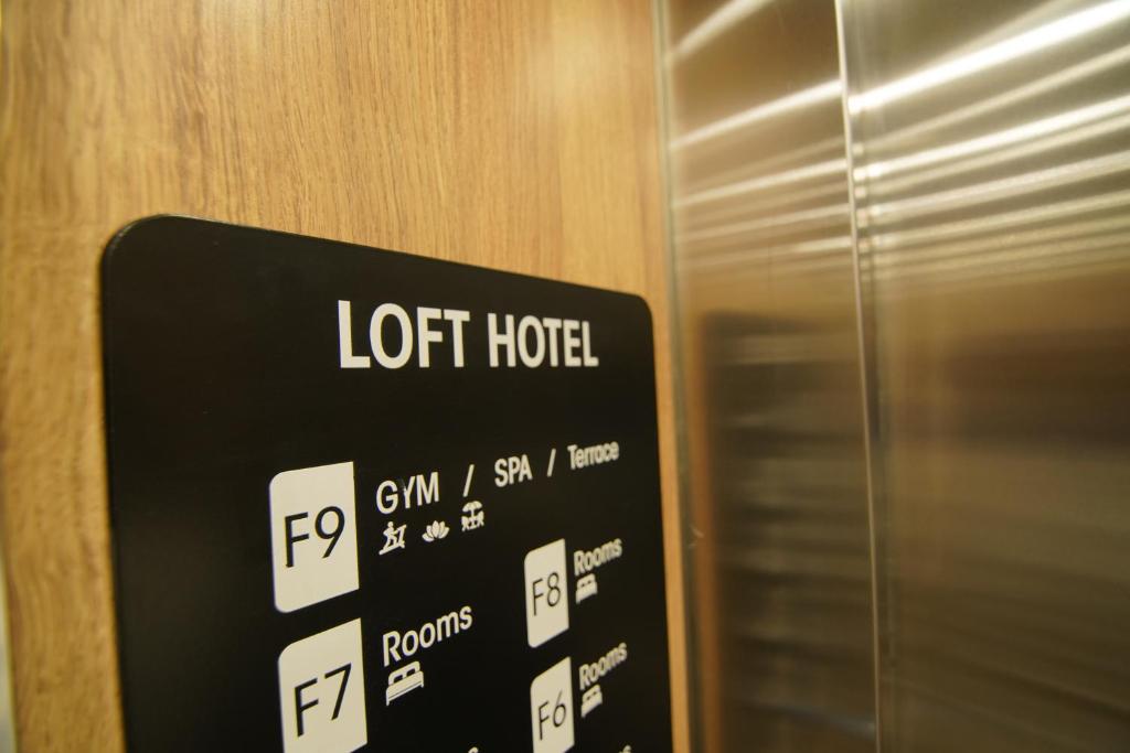 a sign that says light hotel next to a door at Loft Hotel Apartment in Addis Ababa