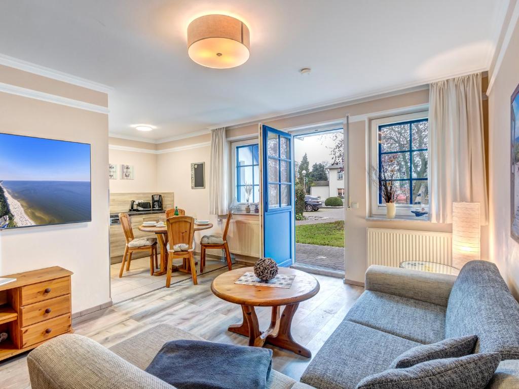 a living room with a couch and a table at Haus Sonnenschein FeWo Seepferdchen in Trassenheide