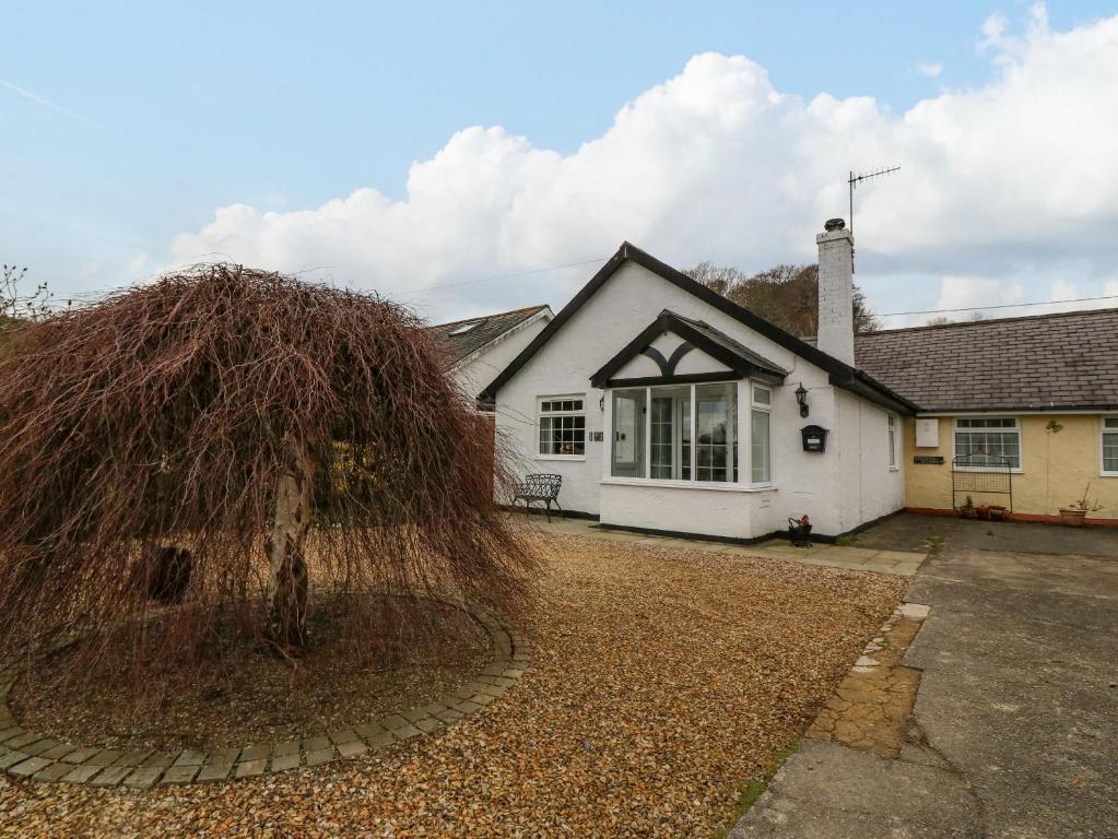 a house with a large pile of grass in front of it at Stepping Stones 1 in Pwllheli