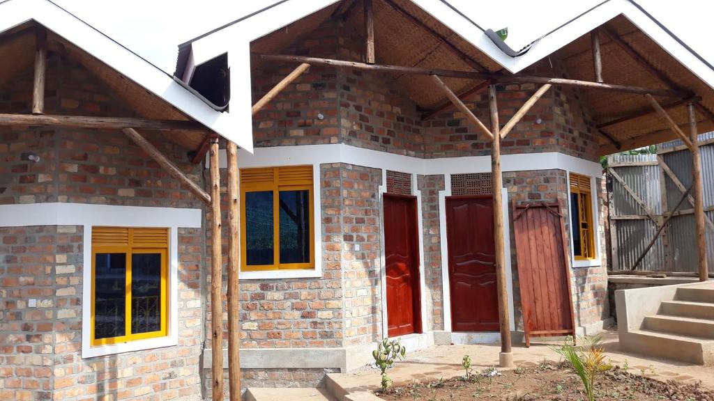 a house under construction with a red door at Aunties Resort - Orutindo Kids Tantenlodge in Muhanga