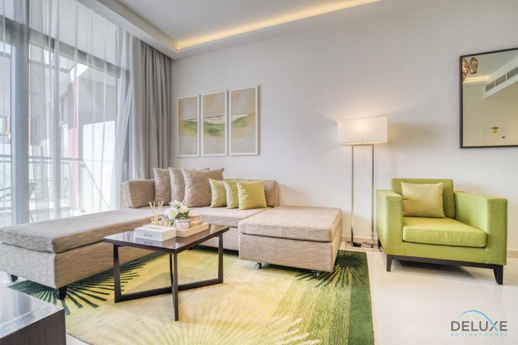a living room with a couch and a chair at Urban 1BR at DAMAC Celestia B Dubai South by Deluxe Holiday Homes in Dubai
