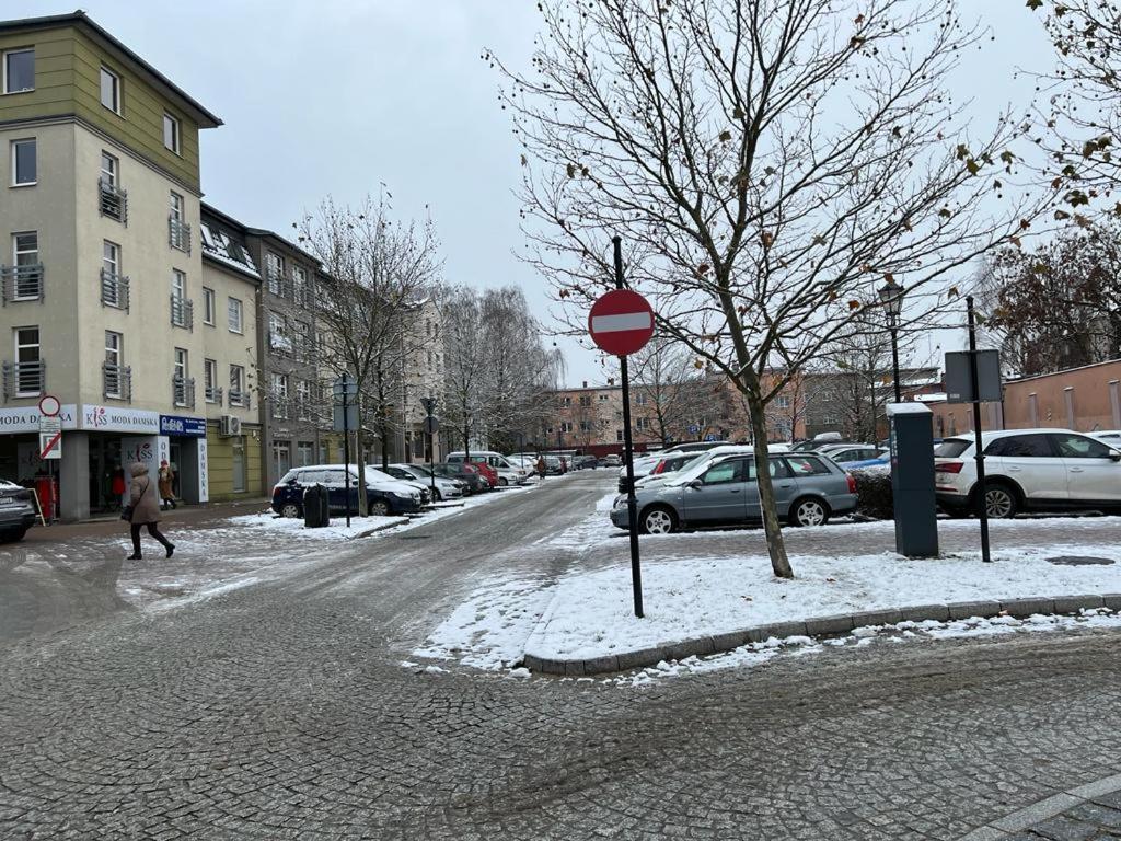 a red stop sign on a snow covered street at Apartament Wałowa in Wejherowo