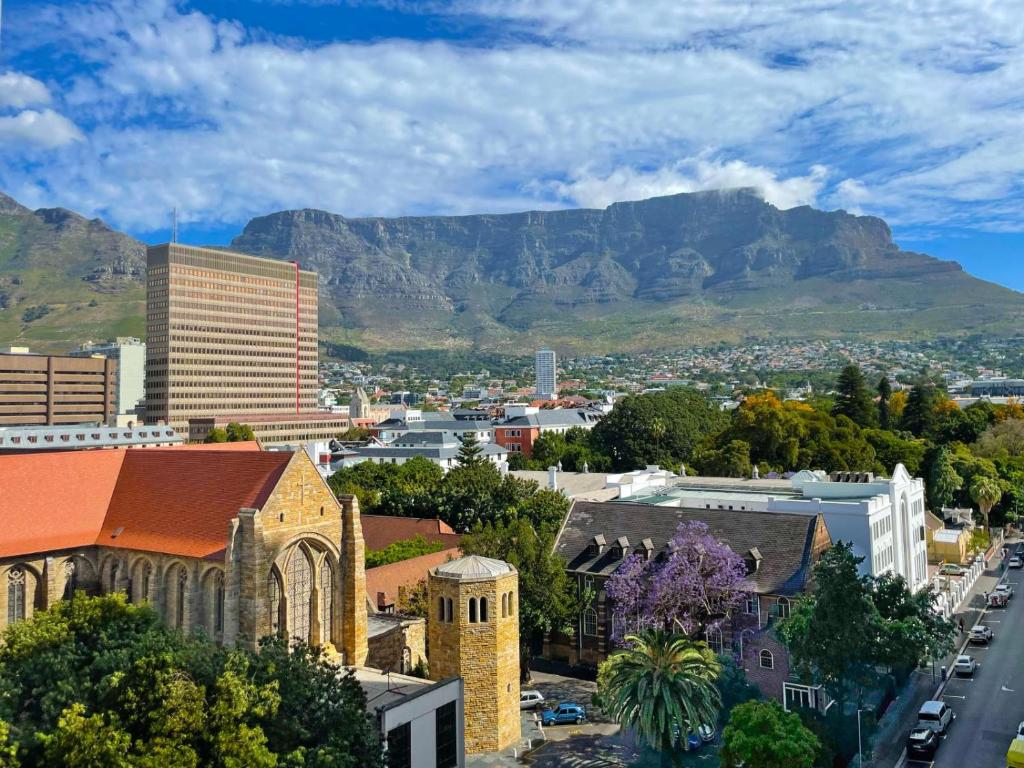 an overview of a city with mountains in the background at Mandela Place Apartment in Cape Town