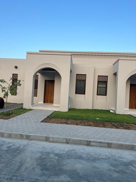 a house with a driveway in front of it at Beach front Le Bon villa in Muscat