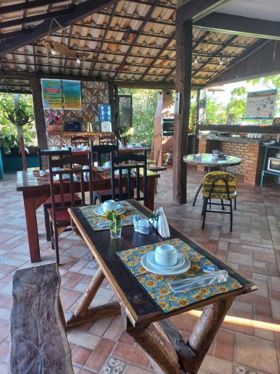 a table with a plate on it on a patio at Pousada Cachoeiras do Cipó in Serra do Cipo