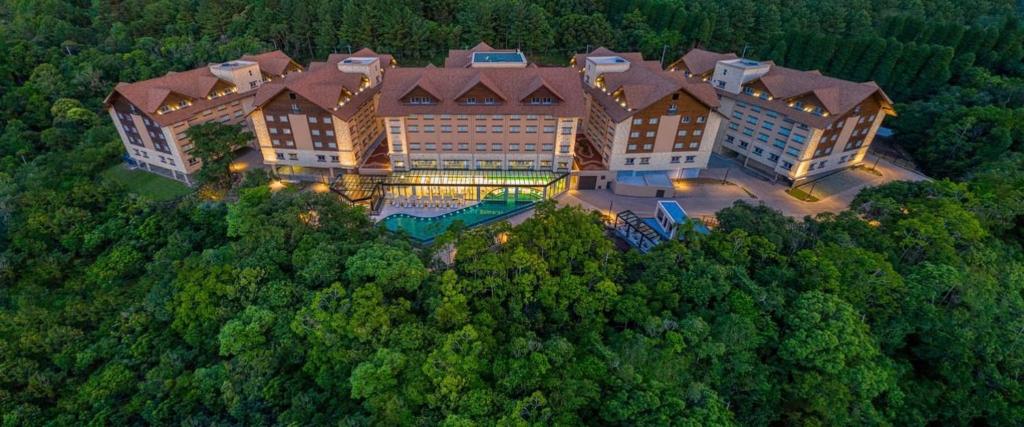 an aerial view of a large building in the forest at Quarto/Apartamento no Wyndham Gramado Termas Resort in Gramado