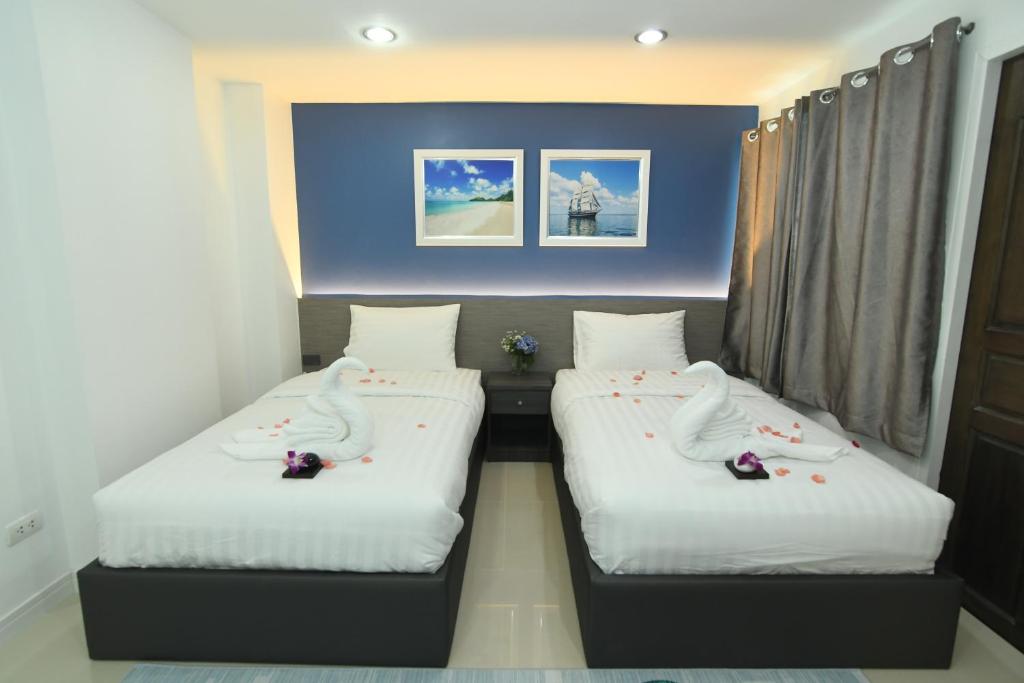 Postel nebo postele na pokoji v ubytování Poonsuk Place Hotel