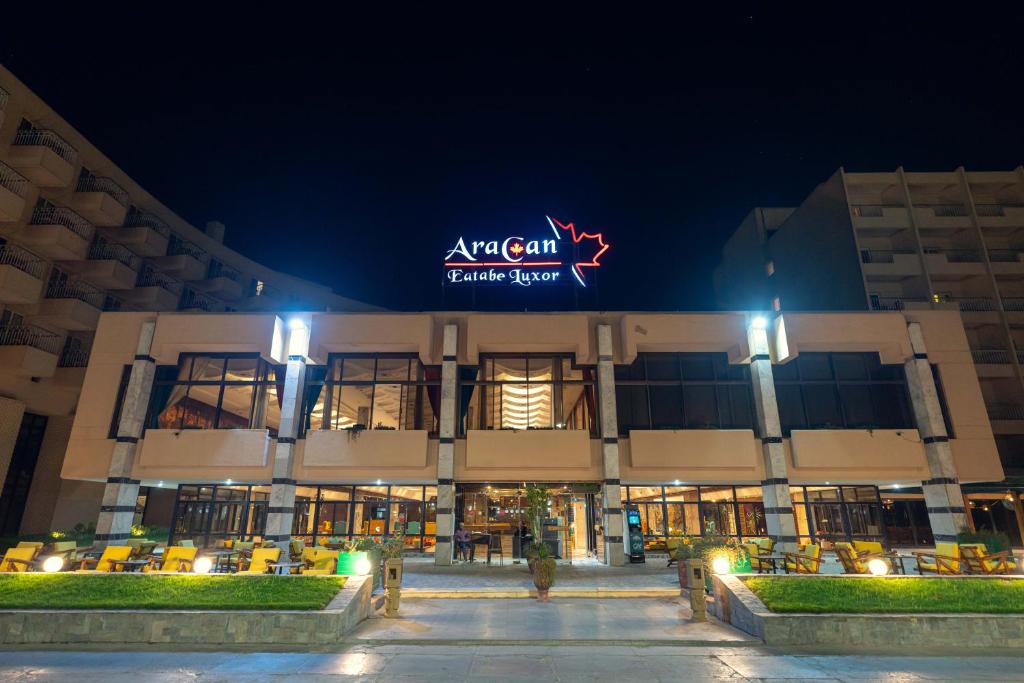 an apartment building at night with a sign on it at Aracan Eatabe Luxor Hotel in Luxor