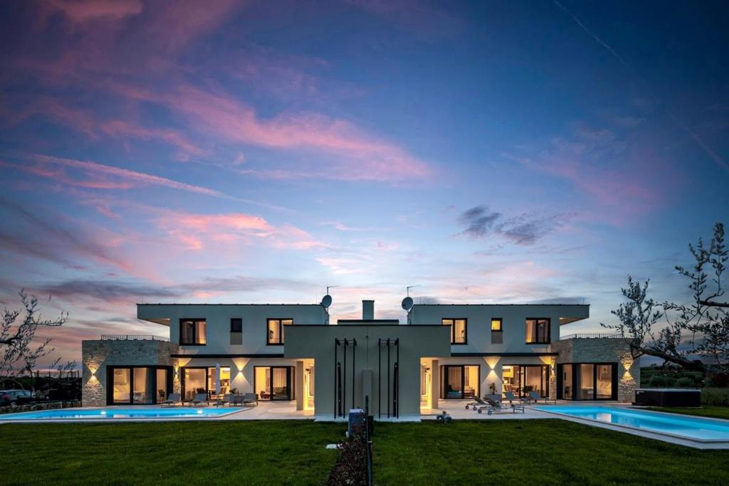 a large house with a pool in front of it at Villa Bella and Chiara by SeeAdria Agency in Brtonigla
