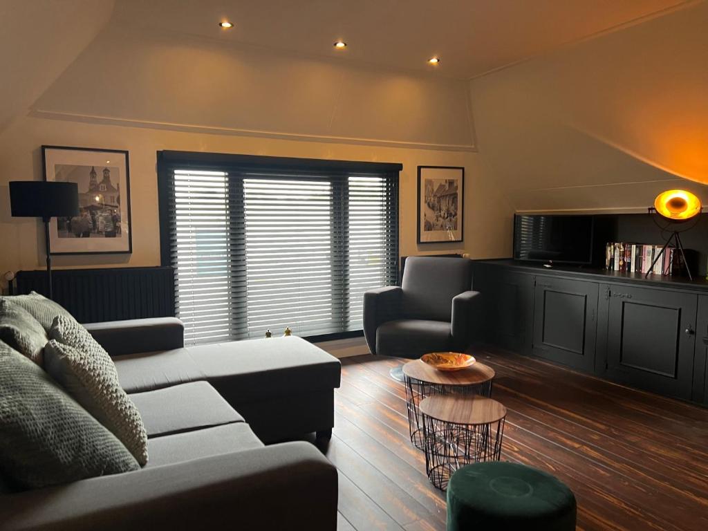 een woonkamer met een bank en een tafel bij Slapen in Ootmarsum in Ootmarsum
