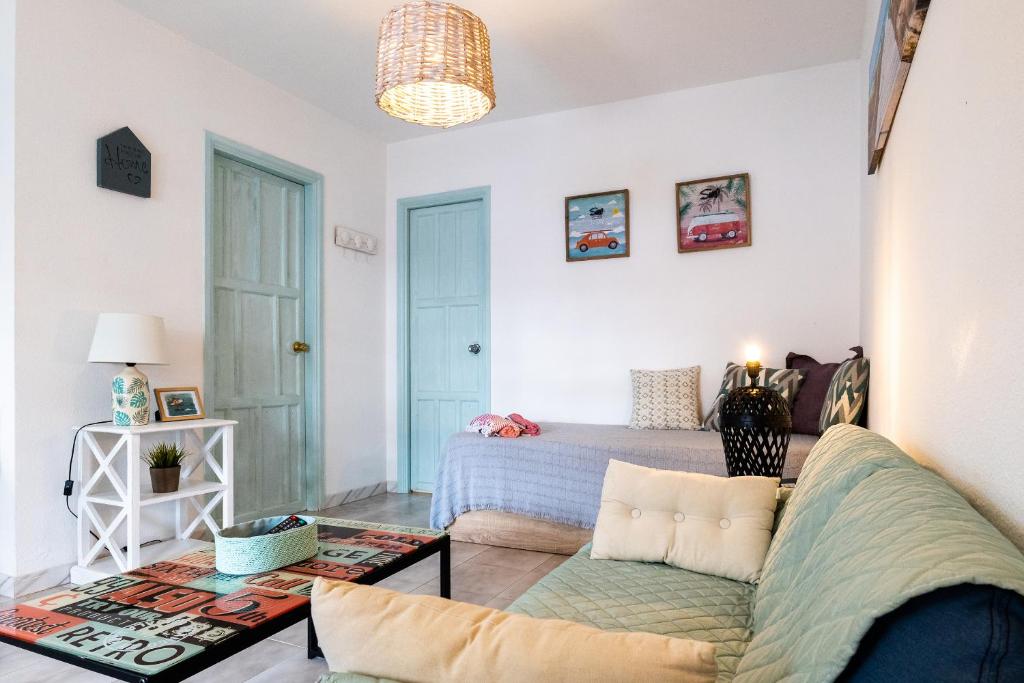 a living room with a couch and a bed at Casa Piquel in Corralejo