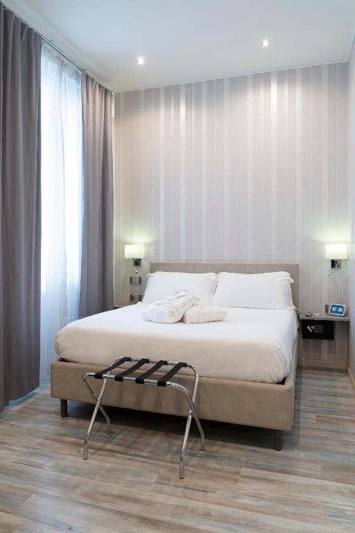 Postel nebo postele na pokoji v ubytování Varese Suites