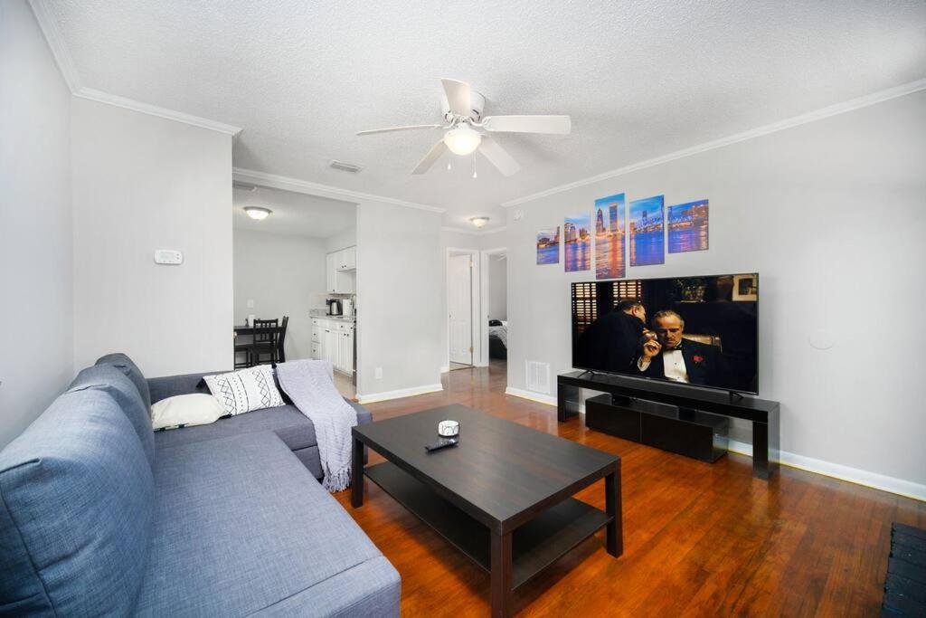 a living room with a blue couch and a table at King Bedroom 2bed1bath Sleeps 5 Close To Town Center Downtown Beach Mayo Clinic in Jacksonville