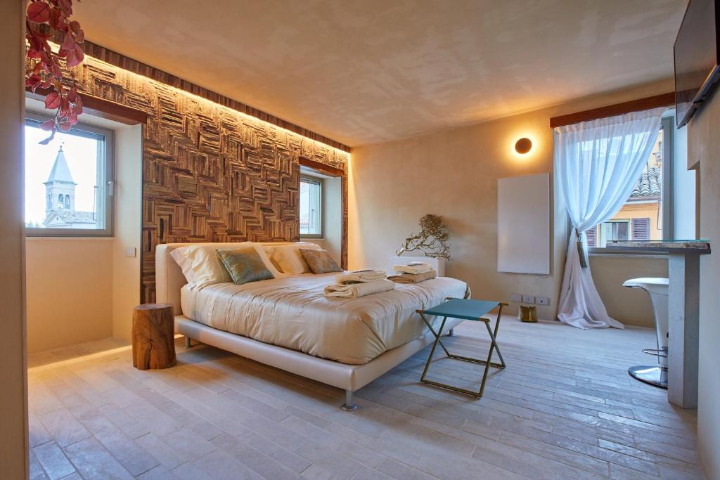 a bedroom with a bed and a large window at One Suite in San Marino
