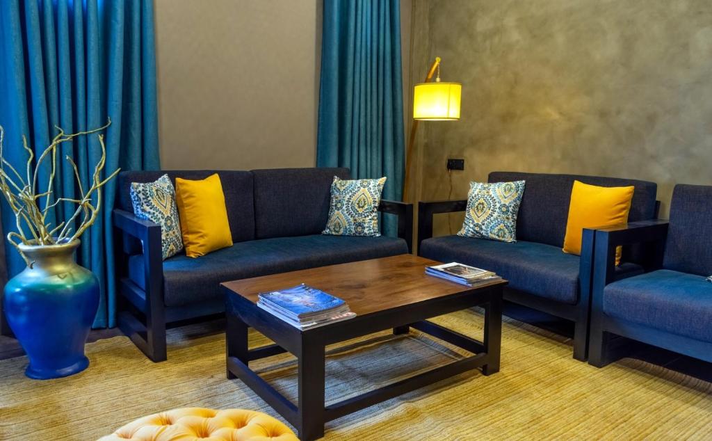 a living room with two couches and a coffee table at Cinnamon Tan Boutique Hotel in Negombo