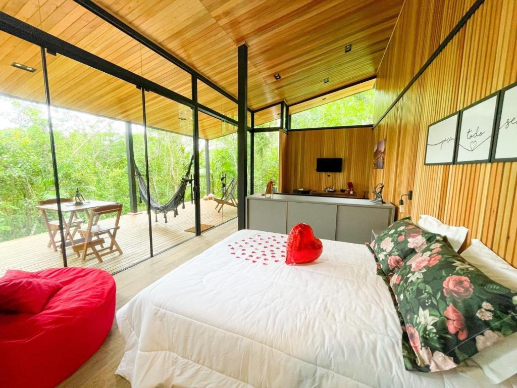 a bedroom with a large white bed in a room at Pousada Sitio Raizes in Siderópolis
