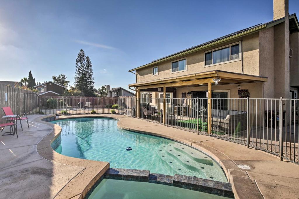 a swimming pool in front of a house at Breeze By the Pool Retreat with Game Room! in Chula Vista