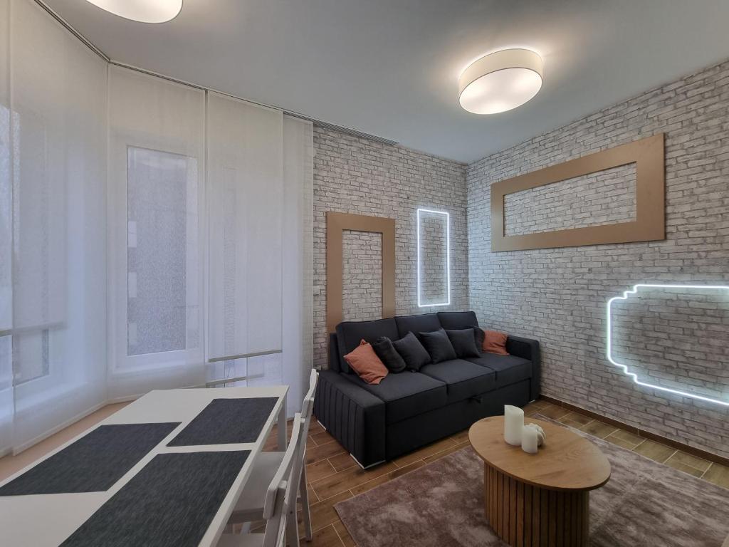 a living room with a couch and a table at Nivalis Hill N&V in Jahorina