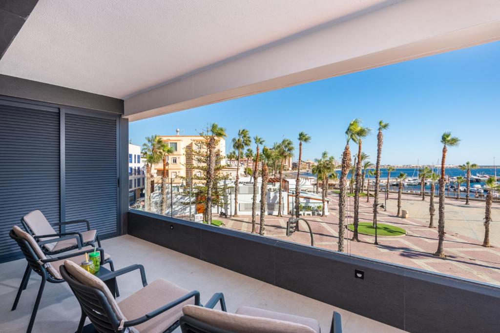 a balcony with chairs and a view of the beach at Spacious beach apartment with seaview Costa Calida in San Pedro del Pinatar