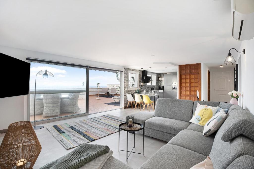 a living room with a couch and a view of the ocean at Casa Hola Mar in Los Realejos