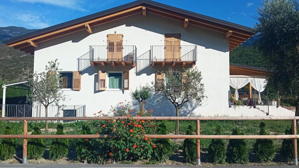 a house with two balconies and a fence at Serendipity House Valle dei Laghi in Sarche di Calavino
