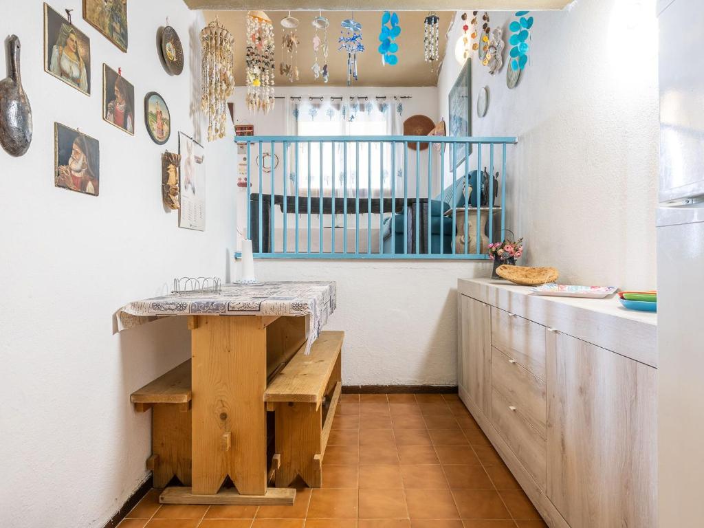 a kitchen with a counter and a table in a room at VILLA CLAUDIO e LUNETTA in Villasimius