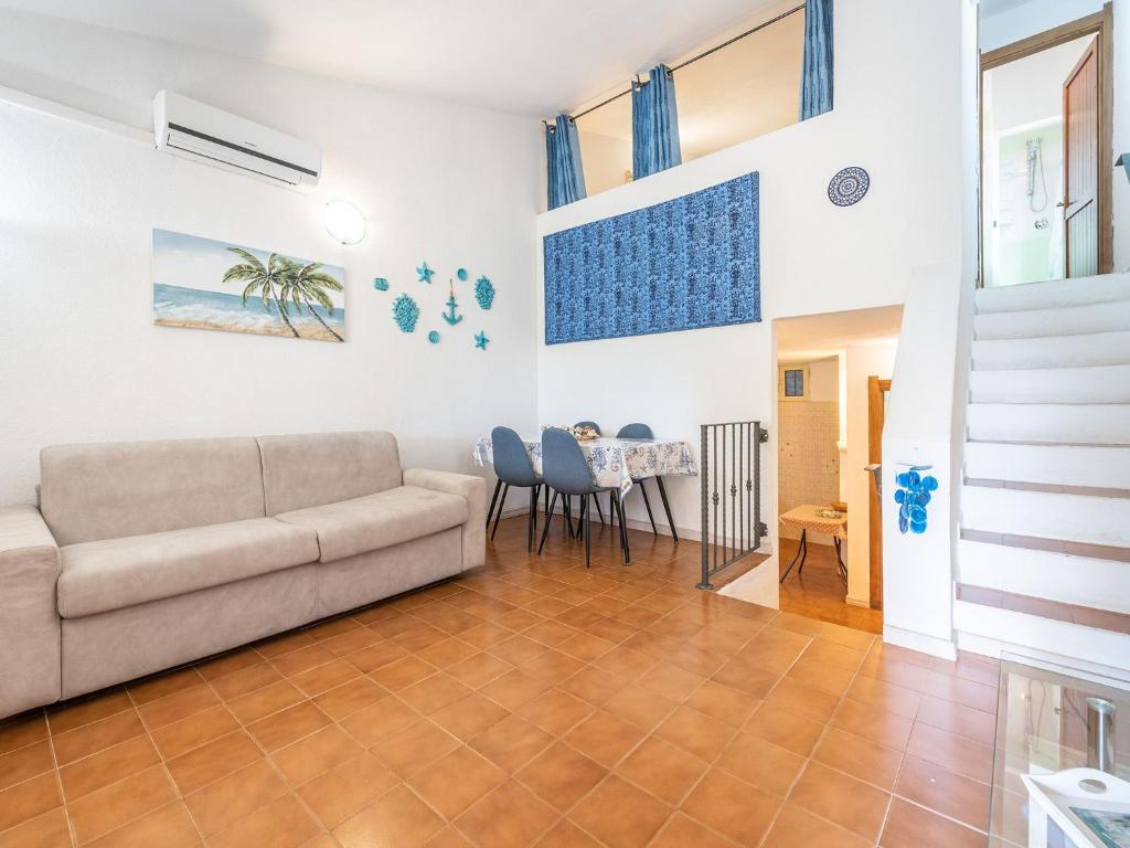a living room with a couch and a table at VILLA CLAUDIO e LUNETTA in Villasimius