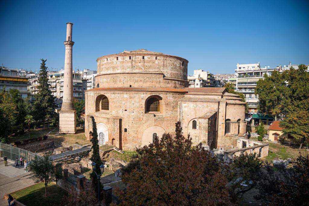 an old brick building with a silo in a city at ROTONDA SKG in Thessaloniki