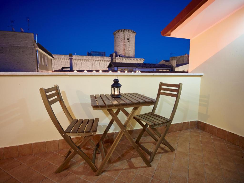 a table and two chairs on a balcony with a view at b&b Casa Fusco in Fondi