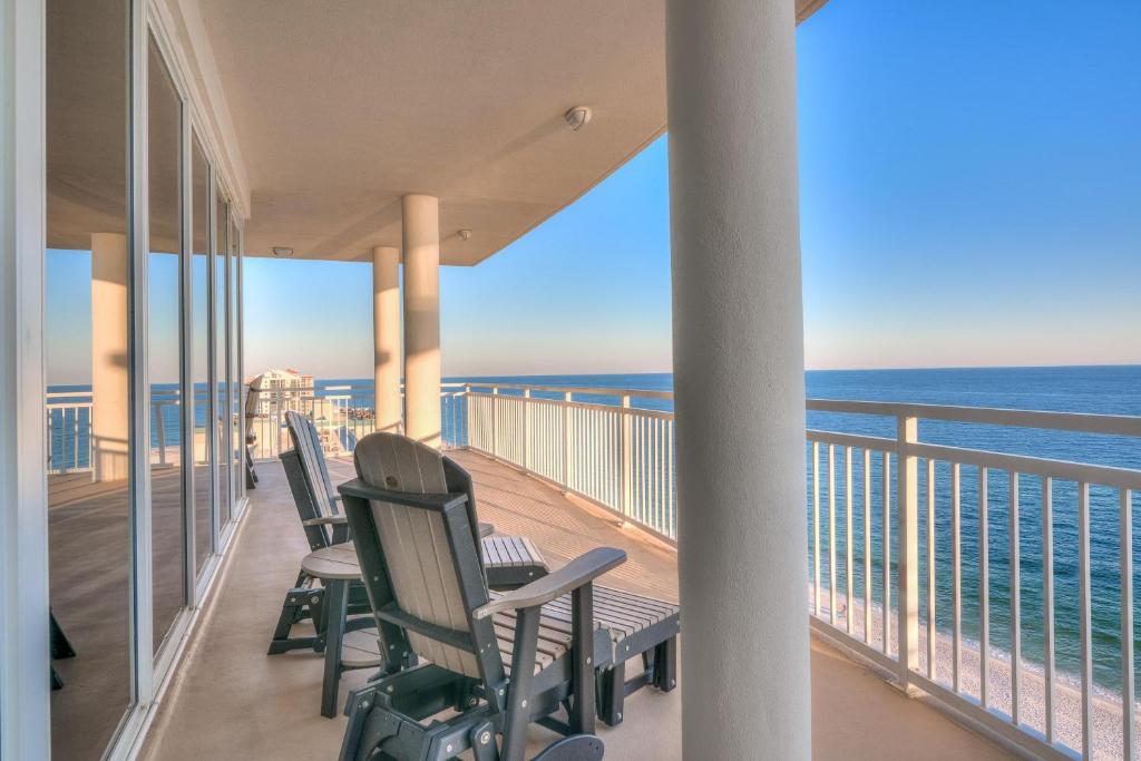 a balcony with chairs and a view of the ocean at La Playa 1001 in Perdido Key